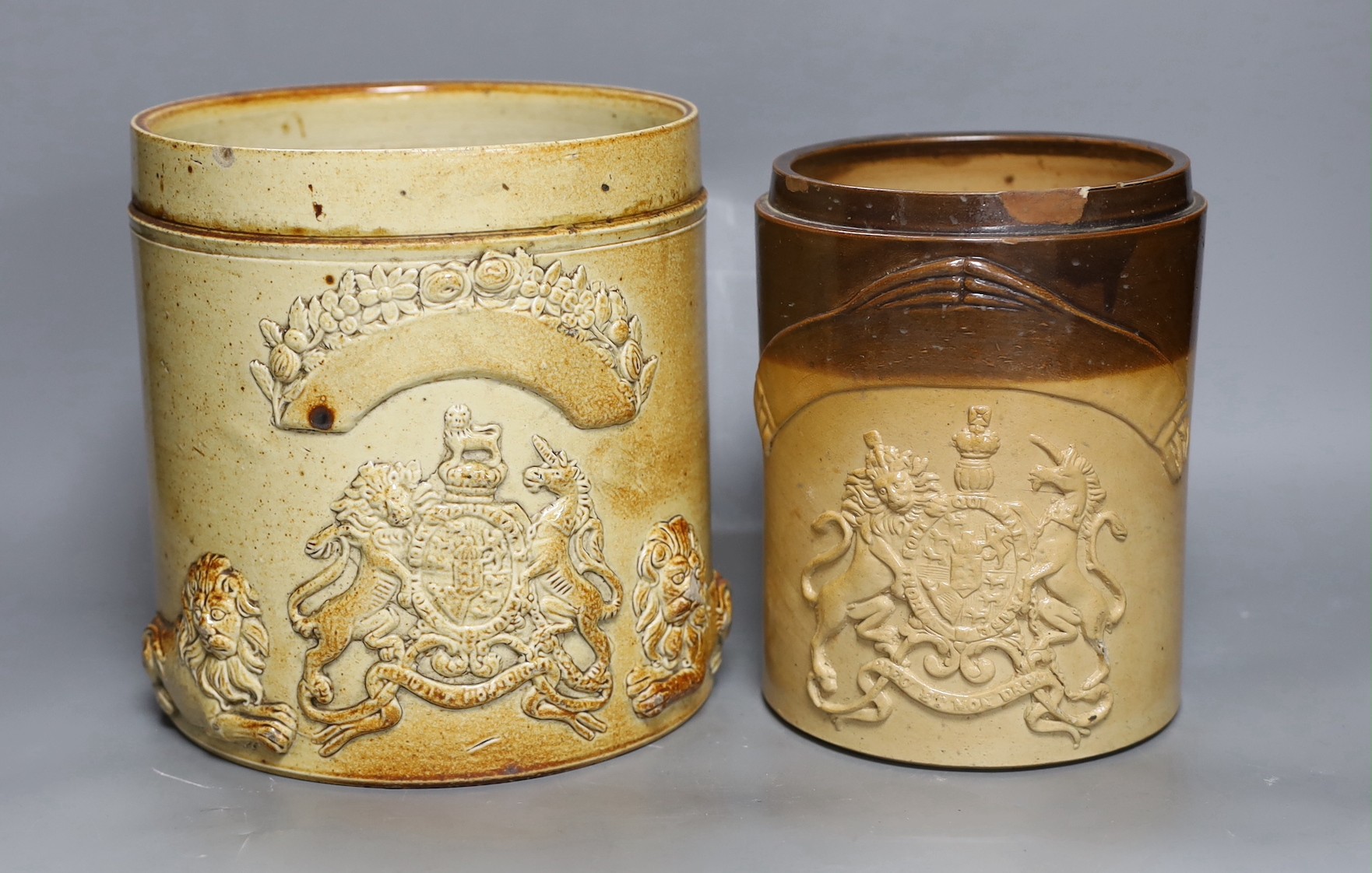 Two 19th century salt glazed stoneware cylindrical storage jars, both with Royal Coat of Arms sprigging, Tallest 20.5cm